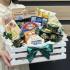 Набор закусок к столу в деревянном ящике: мясная нарезка, сыры, оливки, антипасти